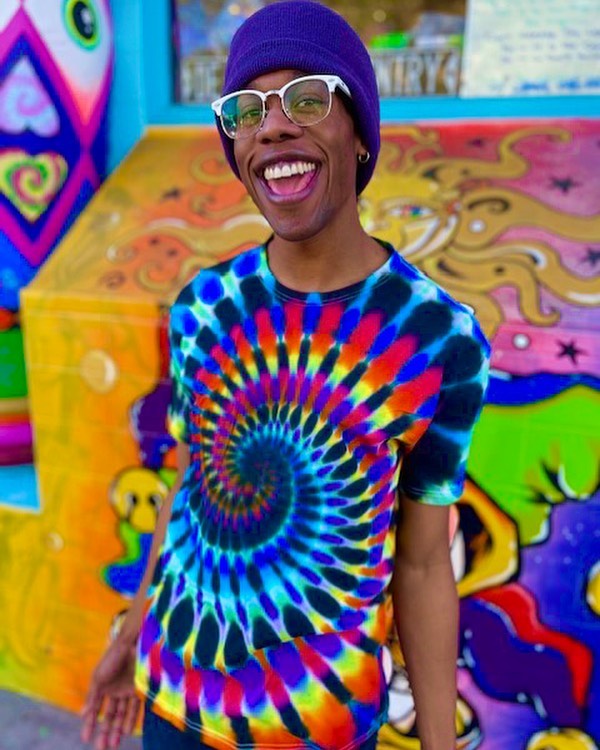 Man in tie dye shirt and black hat